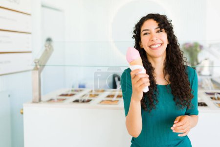Téléchargez les photos : Portrait d'une jeune femme excitée riant et s'amusant en mangeant un cône de crème glacée pendant l'été - en image libre de droit