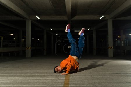 Photo for Latin young urban male dancer breakdancing and enjoying dancing a hip hop freestyle coreography - Royalty Free Image