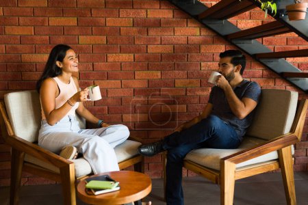 Téléchargez les photos : Joyeux couple heureux rire et s'amuser lors d'un rendez-vous ensemble au café en buvant du cappuccino - en image libre de droit