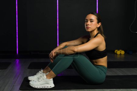 Photo for Portrait of a hispanic young woman looking at the camera wearing activewear ready for her functional training workout at the gym - Royalty Free Image