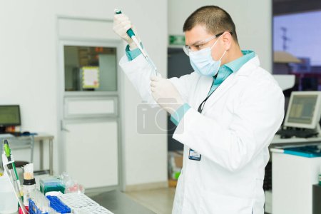 Photo for Lab technician and chemist with safety glasses and gloves using chemical agents while working on medical tests while at the lab - Royalty Free Image