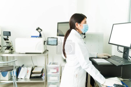 Photo for Young woman and lab technician working as a chemist using the lab equipment while doing medical tests - Royalty Free Image