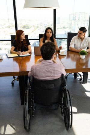 Photo for Man in a wheelchair attending an interview for an open position for a company - Royalty Free Image