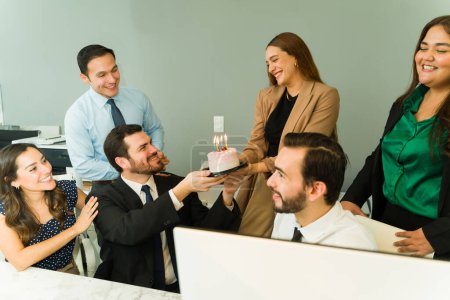 Photo for Group of businesspeople celebrating a birthday with some cake in the office - Royalty Free Image
