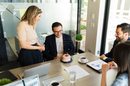 Photo for Portrait of a good looking office worker making a birthday with during his birthday celebration - Royalty Free Image