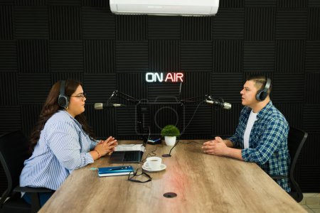 Photo for Young woman with her podcast guest in the recording studio for a talk show or podcast episode - Royalty Free Image