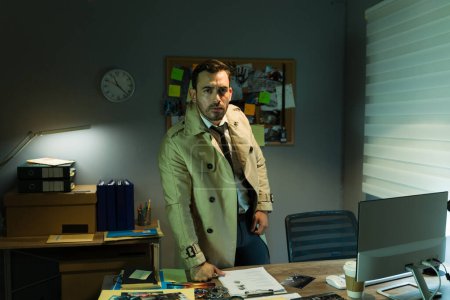 Confident private investigator in a trench coat stands in a dimly lit office, surveying the evidence around him