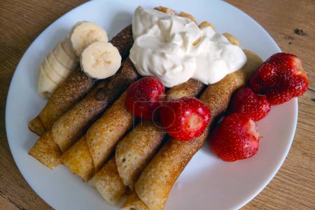 Photo for Delicious light breakfast. Pancakes with sour cream and fruit - Royalty Free Image