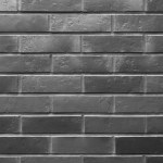A dark background of brick walls of the building. The texture of the brick
