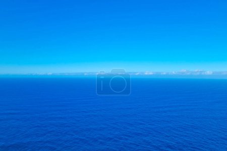 Foto de View from a height on the blue background of the sky and ocean or sea. Background water - Imagen libre de derechos