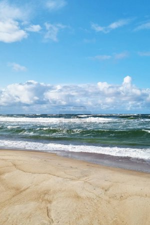 Photo for Vertical photo of sandy coast and waves on the seashore - Royalty Free Image