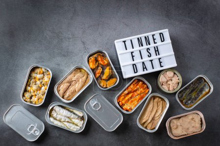 Photo for Assortment of different canned preserved fish and seafood in tin cans ready for tinned fish date night. Cheap and lowbrow food during economic crisis and inflation - Royalty Free Image