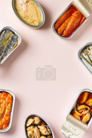 Photo for Assortment of different canned preserved fish and seafood in tin cans ready for tinned fish date night. Cheap and lowbrow food during economic crisis and inflation, copy space - Royalty Free Image