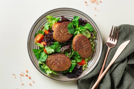 Photo for Plant based meat, vegan cutlet with salad. Food to reduce carbon footprint, sustainable consumption. Lunch concept - Royalty Free Image