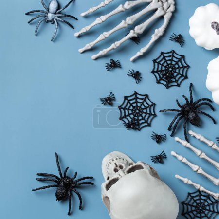 Photo for Happy Halloween, trick or treat greeting card with pumpkin, skulls, bony hands and leaves. Flat lay composition, copy space mockup - Royalty Free Image
