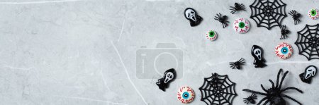 Photo for Happy Halloween, trick or treat greeting card with pumpkin, skulls, bony hands and spiders. Flat lay composition, copy space mockup, banner - Royalty Free Image