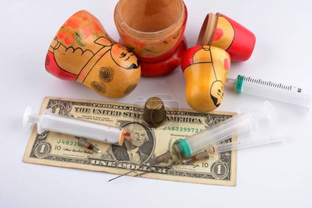 A Russian nesting doll with a dollar and a syringe as a symbol of temptation and cunning.The concept of a global drug trafficking network.