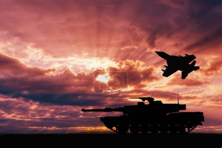 Silhouettes of a battle tank and a flying military aircraft against a dramatic sunset sky. War threats concept.