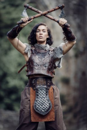 Warrior princess in cosplay battle with axes-