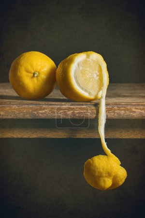 Photo for Lemons on a table, one peeled revealing flesh - Royalty Free Image