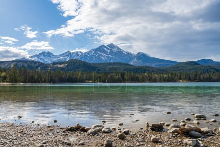 Photo for Lake Annette lake shore beach, Pyramid mountain reflection on the lake. Jasper National Park stunning nature scenery in summer time. Landscape of Canadian Rockies, Alberta, Canada. - Royalty Free Image