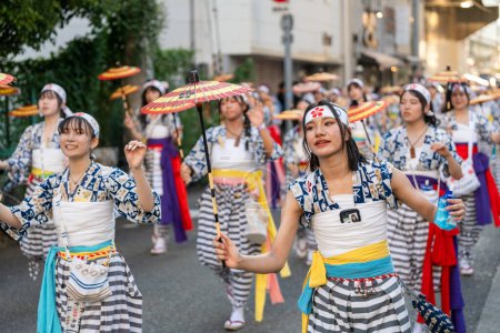 Photo for Osaka, Japan - July 25 2023 : Tenjin Matsuri Festival. Umbrella dancers walking through the streets. - Royalty Free Image