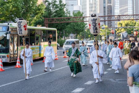 Photo for Osaka, Japan - July 25 2023 : Tenjin Matsuri Festival. People wearing traditional clothes walking through the streets. - Royalty Free Image