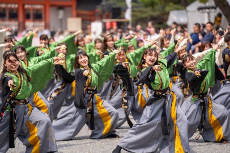 Photo for Kyoto, Japan - March 31 2024 : Kyoto Sakura Yosakoi ( Sakuyosa ) festival. A group of dancers dancing down a street at the Okazaki area around Heian Shrine. - Royalty Free Image