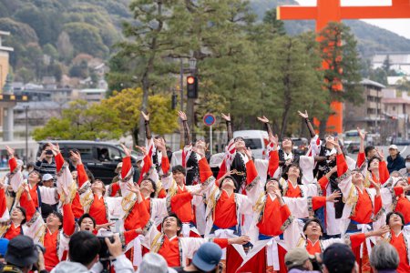 Photo for Kyoto, Japan - March 31 2024 : Kyoto Sakura Yosakoi ( Sakuyosa ) festival. A group of dancers dancing down a street at the Okazaki area around Heian Shrine. - Royalty Free Image