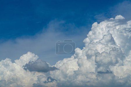 Vast white cumulus clouds with blue sky background