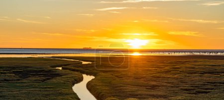 Gaomei Wetlands in sunset time. Sea shore, river, rosy clouds, a beautiful scenery.