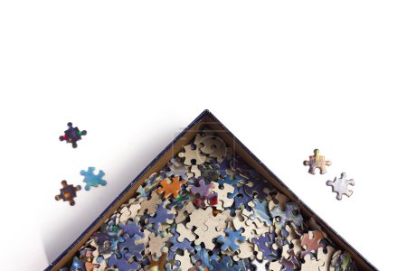 Photo for Box of puzzle pieces separated some placed outside the box - Royalty Free Image