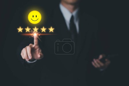 Foto de Businessman customer reviews 5 Stars, Smile with smartphone. Customer service evaluation and satisfaction. Top service, ISO certification, Guarantee, Quality assurance, Standards concept. - Imagen libre de derechos