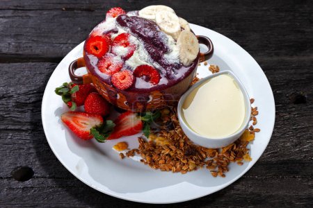 Photo for Acai cream with granola, strawberry, banana, condensed milk - Royalty Free Image
