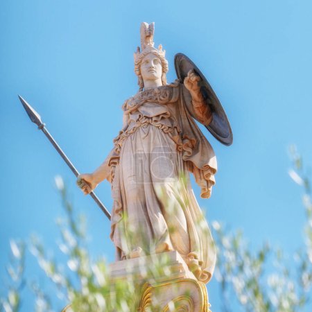 Estatua de mármol de Atenea con casco, lanza y escudo, sobre algunas hojas de olivo, Atenas Grecia