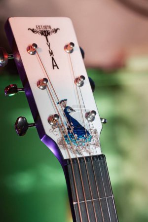 Photo for Vinnytsia, Ukraine - 03.12.2022: Yamaha acoustic guitar headstock on stand, stage of Royal Pub, custom made instrument ready for rock group performance, shallow dof, high noise editorial image - Royalty Free Image