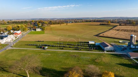 This aerial image displays the vast beauty of Amish farmland at dusk, with a serene sunset backdrop, highlighting the communitys harmonious blend with nature for an Amish wedding.