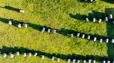 Vom Himmel wirft die geordnete Anordnung der Amisch-Buggys lange Schatten auf das Gras und beschwört am Ende des Tages ein Gefühl der Gemeinschaft und Tradition herauf. während einer Amisch-Hochzeit
