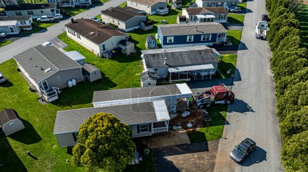 An Aerial View of a Manufactured, Mobile, Prefab Double Wide Home Being Installed in a Lot in a Park