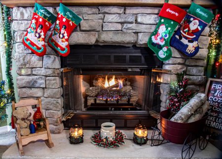 A fireplace with a red and green stocking hanging from it. The stocking is decorated with a santa and a snowman