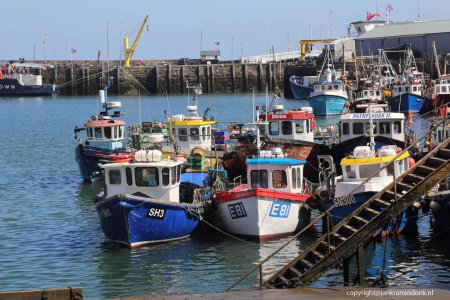 Photo for Scarborough, United Kingdom - June 22, 2022: Fishing boats and cranes in Scarborough harbour, UK on June 22, 2022. - Royalty Free Image