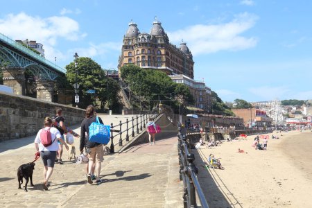 Photo for Scarborough, United Kingdom - June 22, 2022: People walking to the beach and hotel in Scarborough, UK on June 22, 2022. - Royalty Free Image