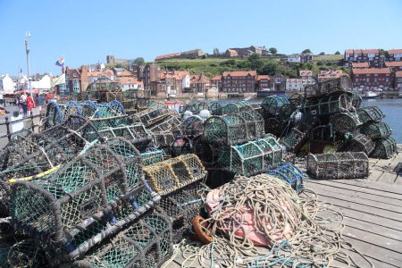Photo for Witby, United Kingdom - June 23, 2022: Fishing nets and people in the harbour of Whitby, UK on June 23, 2025. - Royalty Free Image