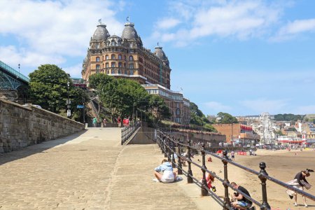 Photo for Scarborough, United Kingdom - June 22, 2022: People, beach and hotel in Scarborough, UK on June 22, 2025. - Royalty Free Image