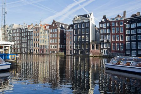 Photo for Historical houses along an Amsterdam canal in Holland - Royalty Free Image
