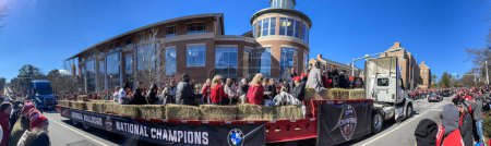 Photo for Athens, GA / USA - January 14, 2023:  A panorama shows UGA football staff riding on flatbed truck in the football team's national championship victory parade on January 14, 2023 in Athens, GA. - Royalty Free Image