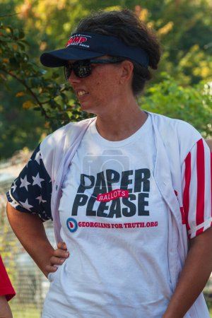 Photo for Atlanta, GA / USA - August 24, 2023:  A woman wears a shirt that says "Paper Ballots Please" while awaiting Donald Trump's arrest at the Fulton County Jail on August 24, 2023 in Atlanta, GA. - Royalty Free Image