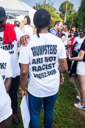 Photo for Atlanta, GA / USA - August 24, 2023:  African-American men hold signs reading "Blacks for Trump" and wear tee-shirts to support the indicted ex-President  outside the Fulton County Jail on August 24, 2023 in Atlanta, GA. - Royalty Free Image