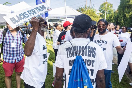 Photo for Atlanta, GA / USA - August 24, 2023:  African-American men hold signs reading "Blacks for Trump" and wear tee-shirts to support the indicted ex-President  outside the Fulton County Jail on August 24, 2023 in Atlanta, GA. - Royalty Free Image