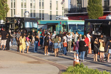 Téléchargez les photos : Suwanee, GA / USA - Le 4 août 2023 : Des dizaines de personnes font la queue en attendant de commander des camions alimentaires pendant le Food Truck Vendredi, 4 Août 2023 à Suwanee, GA. - en image libre de droit